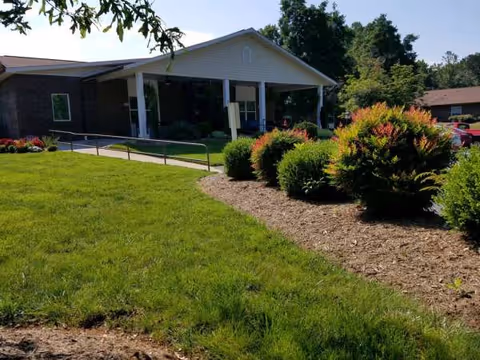 Front view of Brockford Inn with landscaped lawn, shrubs, and accessible entrance.