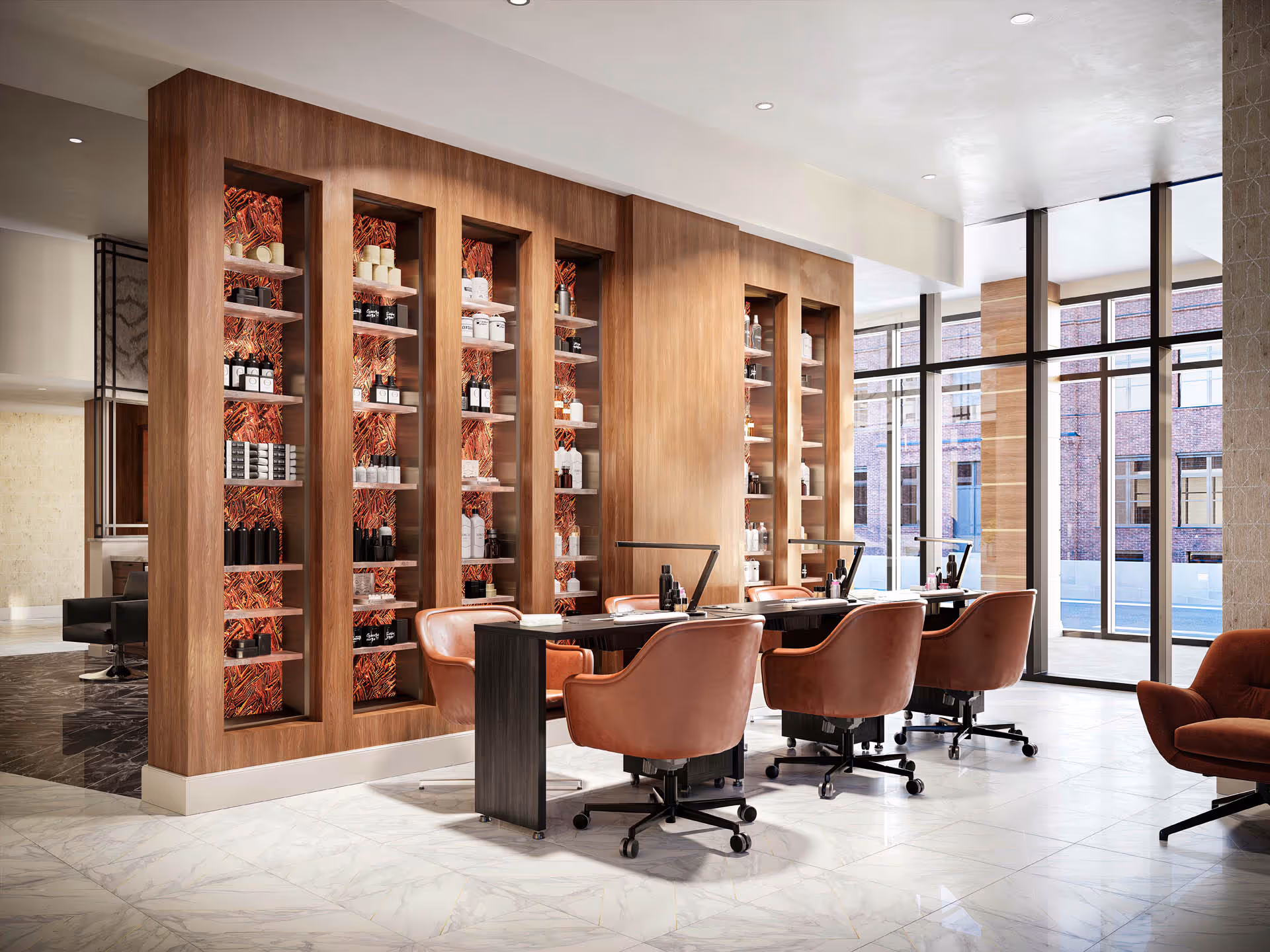 A modern interior space featuring a row of four brown leather swivel chairs positioned at a long black table with desk lamps. Behind the chairs is a wooden shelving unit with multiple compartments displaying various bottles and containers. Large floor-to-ceiling windows allow natural light to fill the room, and a brick building is visible outside.