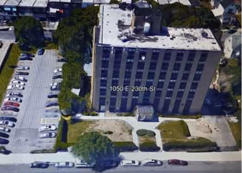 Aerial view of Laconia Nursing Home, showing the multi-story building, parking lot, and surrounding landscaping.