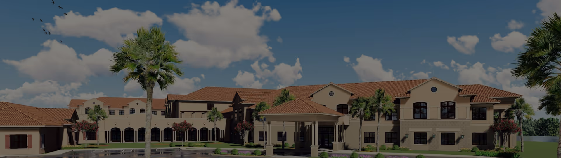 Exterior view of a large senior living facility building with beige walls and a red-tiled roof, surrounded by palm trees and landscaped greenery under a partly cloudy blue sky.