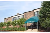 Exterior view of Autumn Lake Healthcare at Loch Raven with a green entrance canopy.