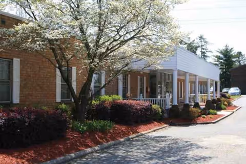 Exterior view of Durham Nursing & Rehabilitation Center with a covered front porch.