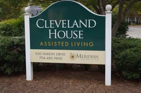 A green Cleveland House sign for assisted living, with address and Meridian logo.
