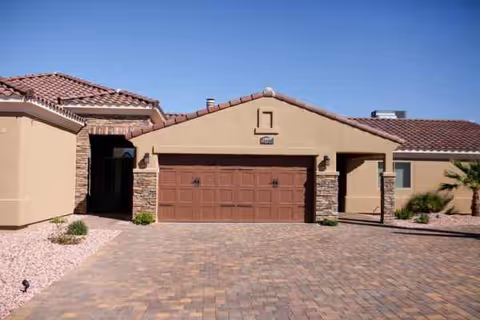 Front exterior of a single-story assisted living home with a two-car garage.