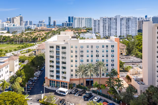 Aerial view of The Sterling Aventura senior living building with surrounding high rises.