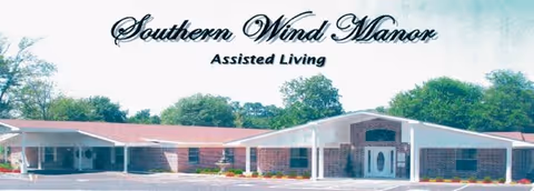 Front view of Southern Wind Manor assisted living building with its name displayed above.