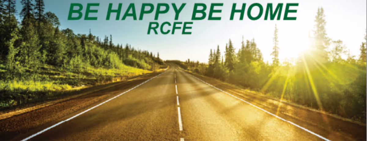 Sunlit road through trees with bold green 'BE HAPPY BE HOME' slogan across the top.