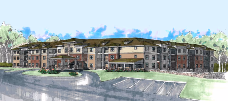 Illustration of a large three-story senior living facility building with multiple windows, a covered entrance, and surrounding greenery including trees and shrubs. There is a parking area in front of the building with marked parking spaces.