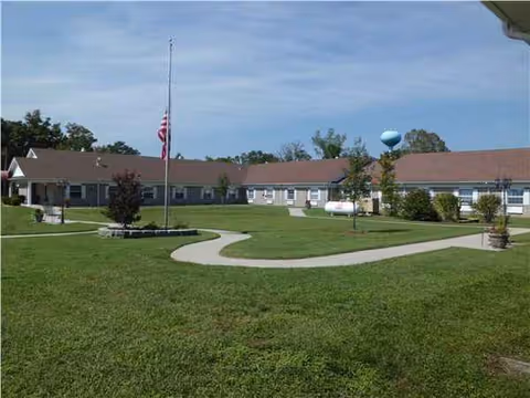 Single-story Forsyth Care Center exterior with curved walkway across a green lawn.