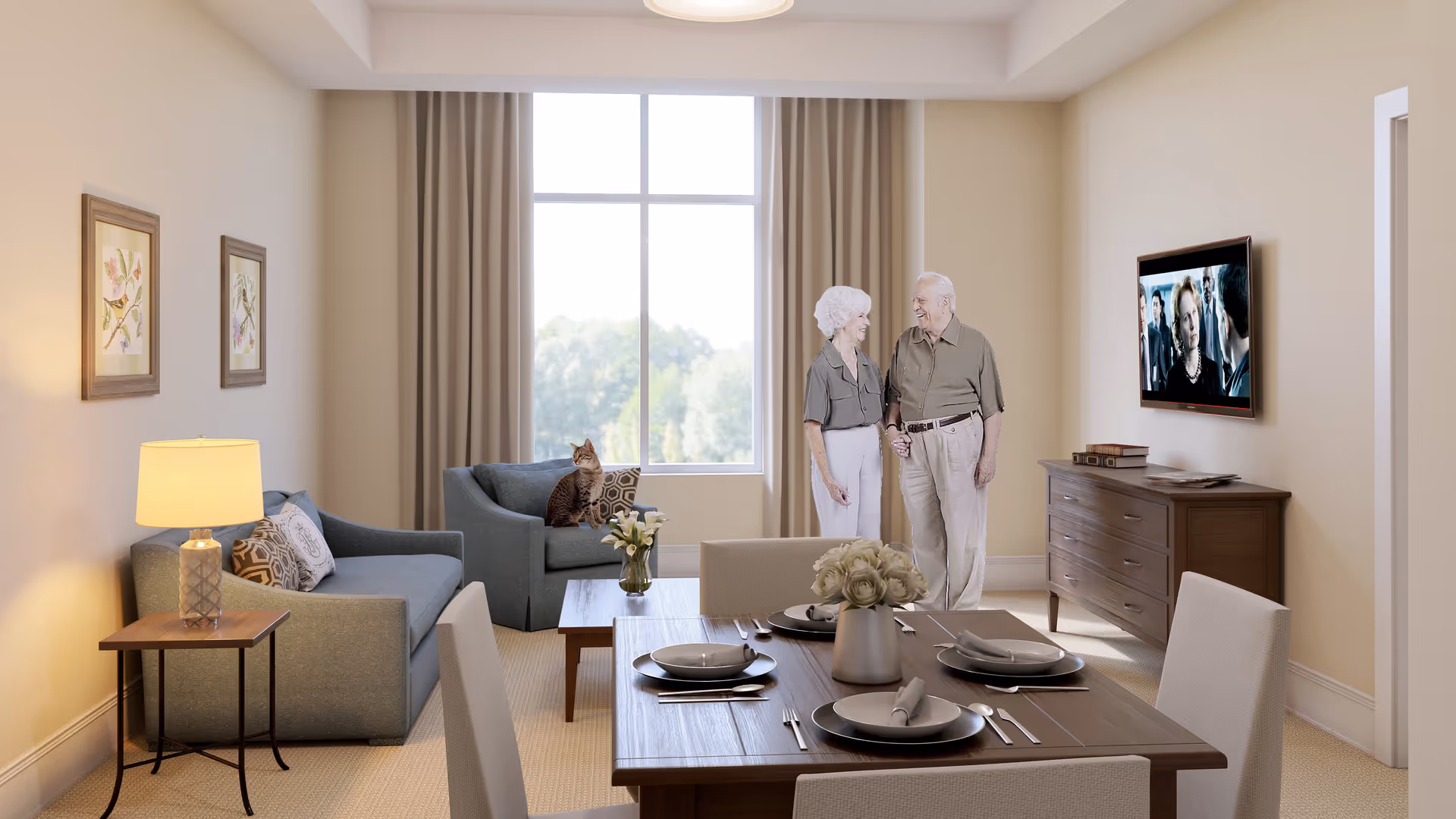 A cozy living room with beige walls and carpet, featuring a dining table set for four with plates and cutlery, a blue sofa and armchair, a side table with a lamp, a wooden dresser with a TV mounted above it, and a large window with beige curtains. An elderly couple is standing near the TV holding hands, and a cat is sitting on the armchair by the window.