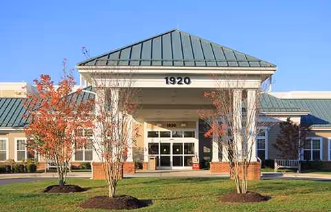Front entrance of Citizens Care and Rehabilitation Center with brick columns and a green roof.