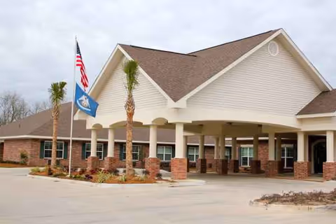 Front view of Pelican Pointe Healthcare and Rehabilitation entrance with brick columns.