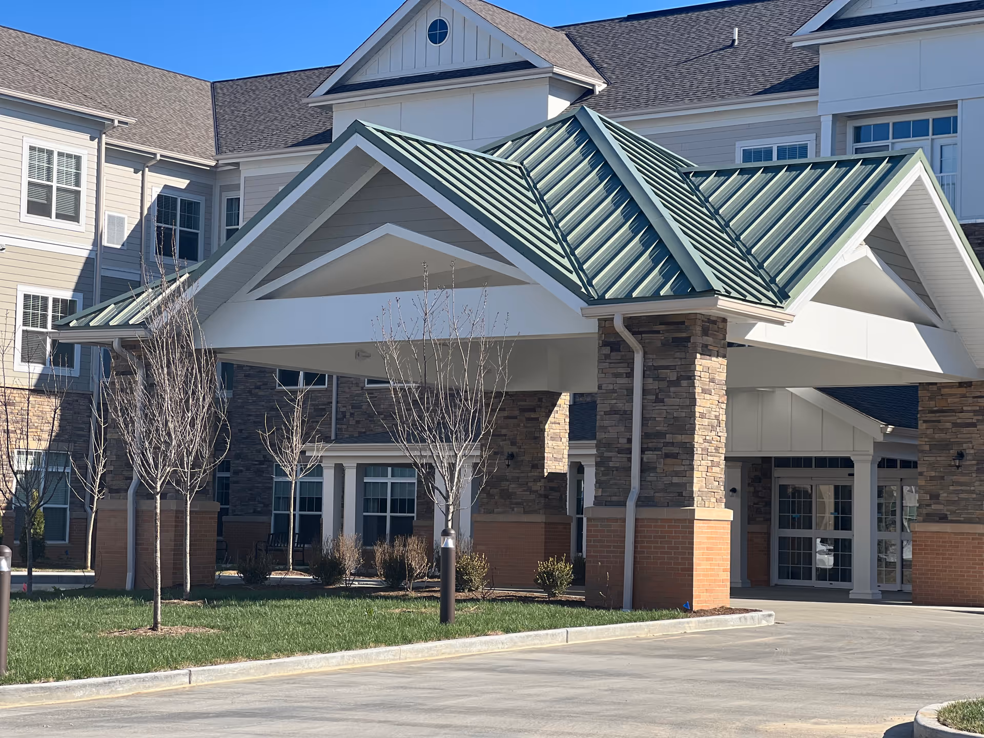 Exterior view of The Lumiere of Chesterfield with porte-cochere and stone columns.