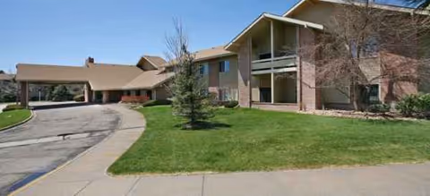 Curved driveway leads to Brookdale Meridian Lakewood facility with brick exterior and manicured lawn.