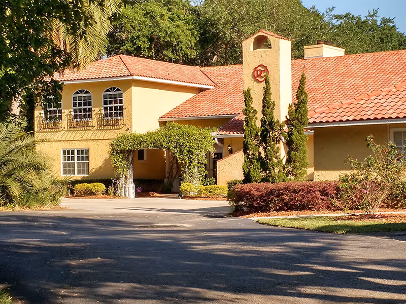 Exterior view of Angels Senior Living at Palm Harbor showcasing the building and landscaping.
