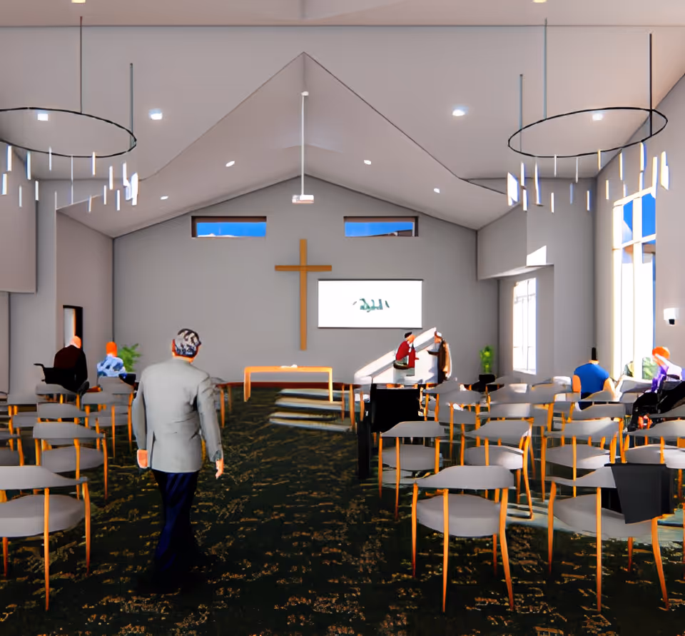 Interior view of a senior living facility chapel with rows of chairs facing a stage with a wooden cross on the wall. Several people are seated or walking inside the chapel, which has high ceilings and modern circular light fixtures.