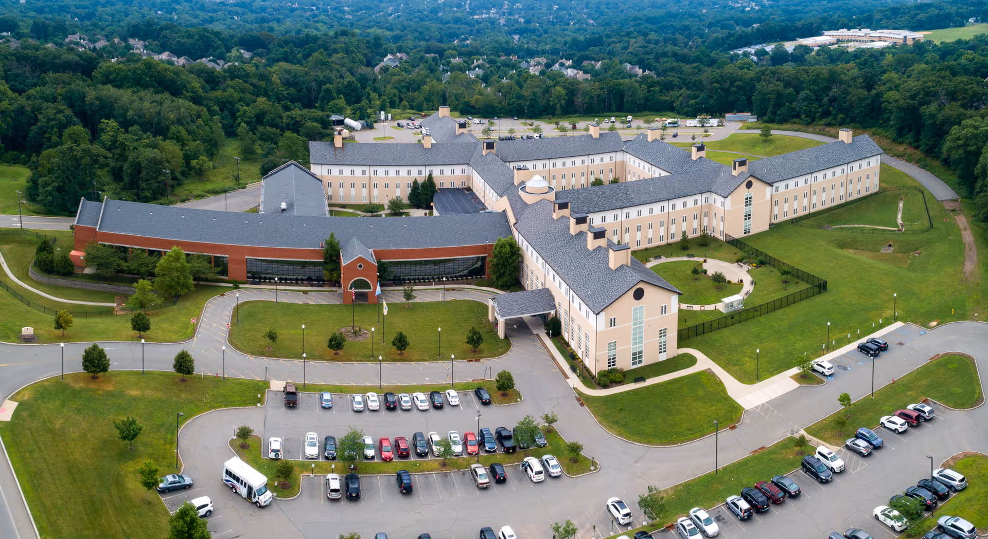 Aerial view of Preakness Healthcare Center, a large multi-wing building with surrounding parking lots, driveways, and green lawns.
