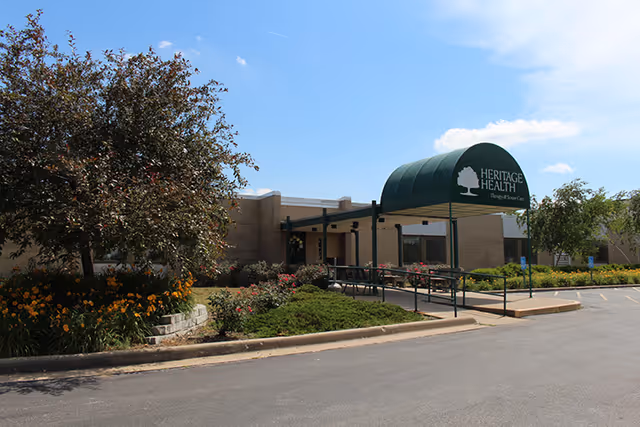 Exterior view of the Beardstown Health and Rehab Center featuring landscaping and an entrance awning.