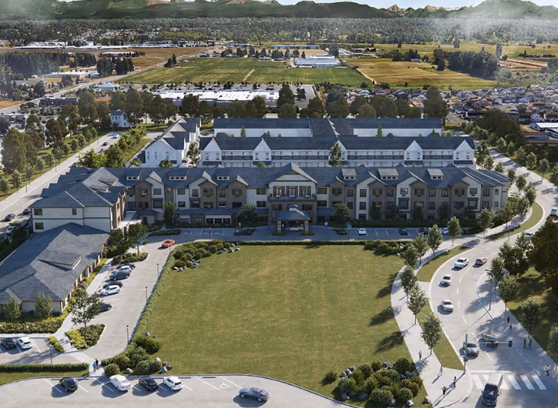 Aerial view of Fields Senior Living campus with a large front-facing building and parking.