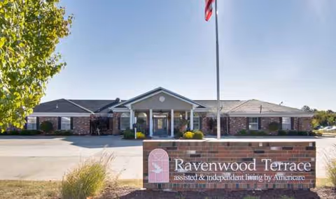 Front view of Ravenwood Terrace assisted living facility with entrance canopy and sign.
