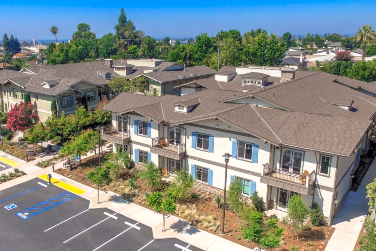 Aerial view of Santa Teresita Assisted Living Cottages exterior with parking.