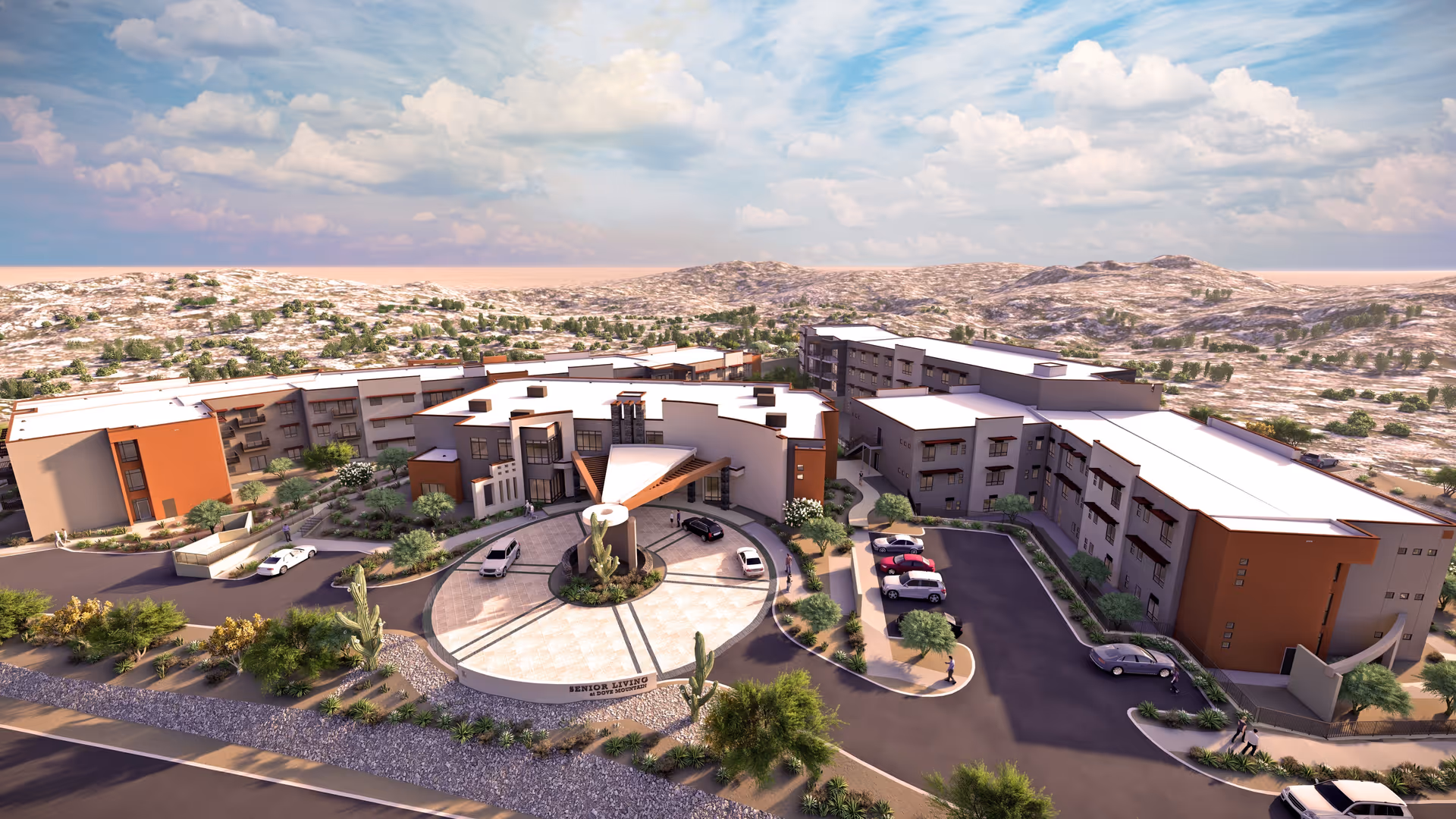 Aerial view of the La Sonora at Dove Mountain senior living complex with a circular driveway, parked cars, and surrounding desert landscape.