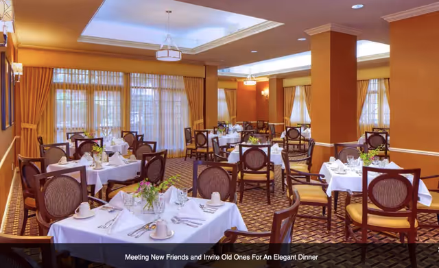 Elegant dining room with multiple set tables, chairs, and warm lighting.