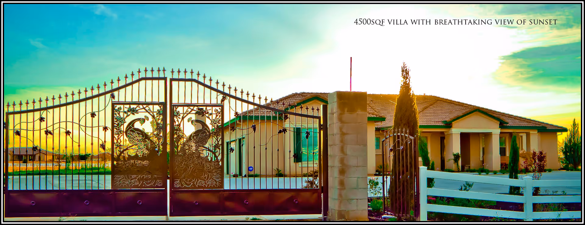 Ornate wrought-iron gated entrance in front of a large single-story villa at sunset.