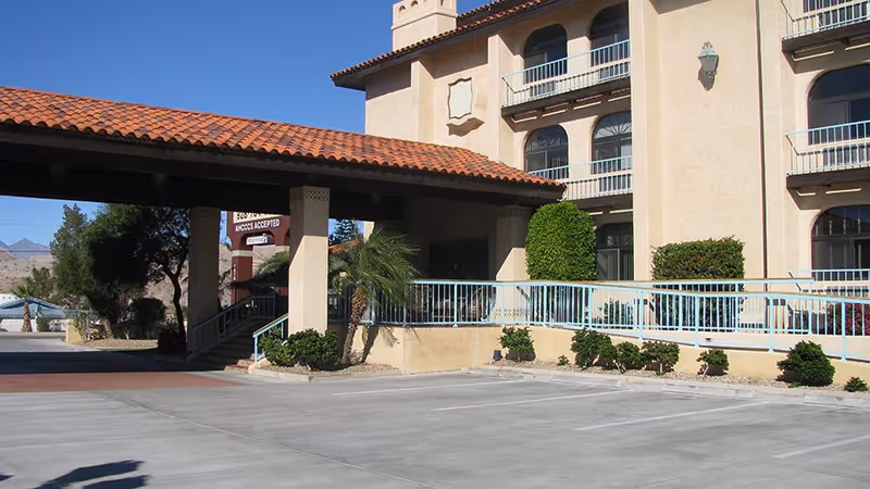 Exterior view of Silver Creek Assisted Living building with a covered entrance and landscaped area.