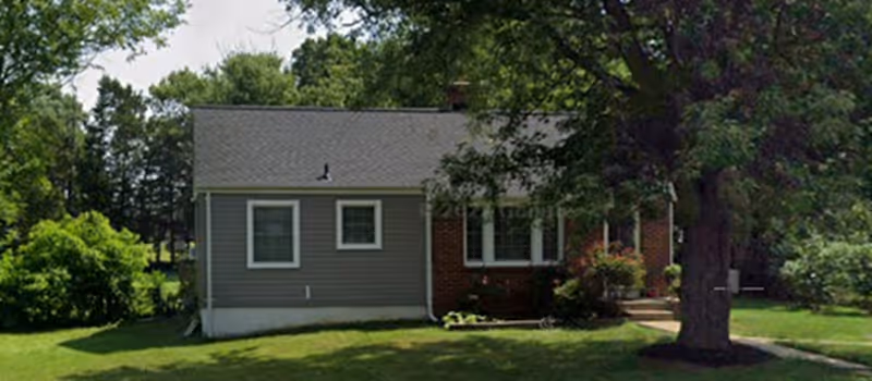 Advent Eldercare exterior: a single-story gray building with brick accent on green lawn