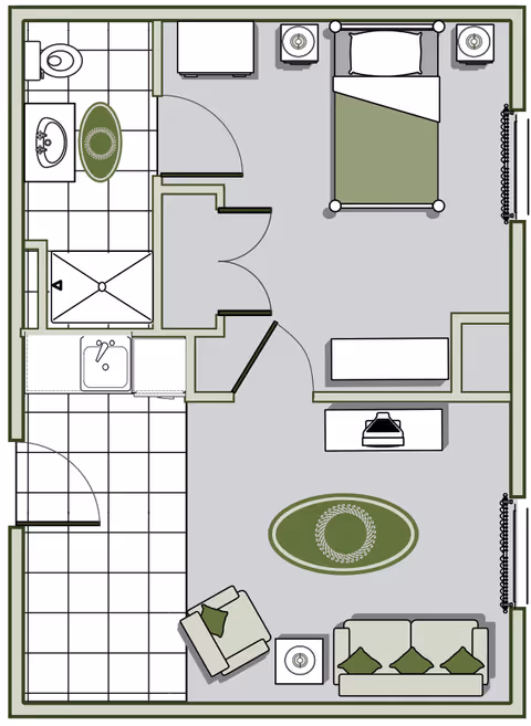Top-down floor plan of a one-bedroom senior living apartment showing a bedroom, bathroom, kitchenette/entry, and a furnished living area.