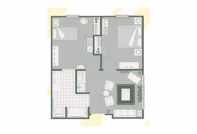 Floor plan of a residential unit showing two bedrooms, a bathroom with a bathtub and toilet, and a living room area with seating and a fireplace. The layout includes closets and a small kitchen area between the bedrooms.