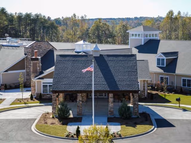 Spring Park senior living facility exterior with a covered entrance and flagpole.