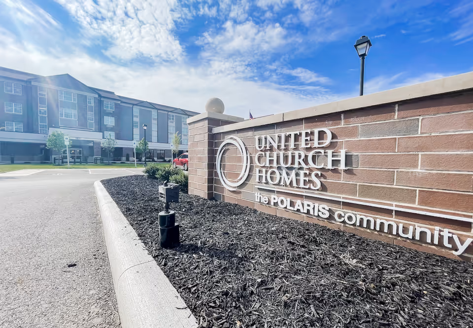 Exterior view of United Church Homes Polaris Community sign and building.