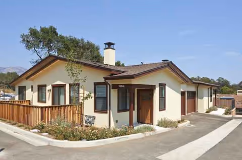 Exterior view of a single-story Valle Verde facility with beige walls and deck.