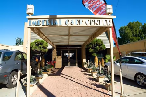 Front entrance of Imperial Care Center with a covered walkway and potted plants.