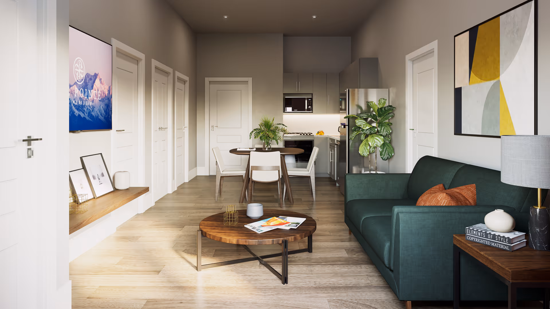 A modern, open-concept living space featuring a green sofa with orange pillows, a wooden coffee table with magazines and decorative items, a dining table with four chairs, and a kitchen area with stainless steel appliances and cabinetry. The room has light wood flooring, neutral-colored walls, and contemporary artwork on the walls. There are several white doors along the left wall and a potted plant near the kitchen.