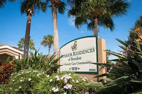 Exterior view of Best Care Senior Living at Brandon entrance with landscaped sign.