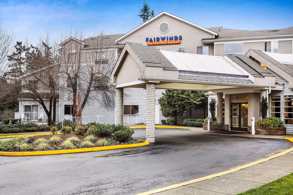 Exterior view of Fairwinds Brighton Court senior living building with entrance canopy.