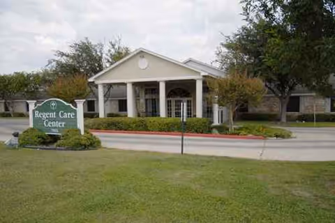 Exterior view of Regent Care Center of Laredo entrance with sign and lawn.
