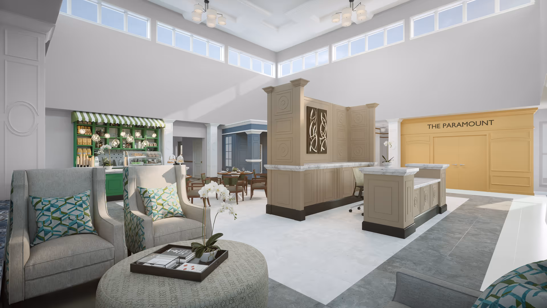A bright and spacious interior common area with high ceilings and large windows near the ceiling letting in natural light. The room features a seating area with two gray armchairs and a round ottoman with a tray and a white orchid on it. In the background, there is a green and white striped awning over a small café or snack bar area with hanging lights. To the right, there is a beige reception desk with decorative panels and a sign on the wall behind it that reads 'THE PARAMOUNT'. Several dining tables and chairs are visible further back in the room.
