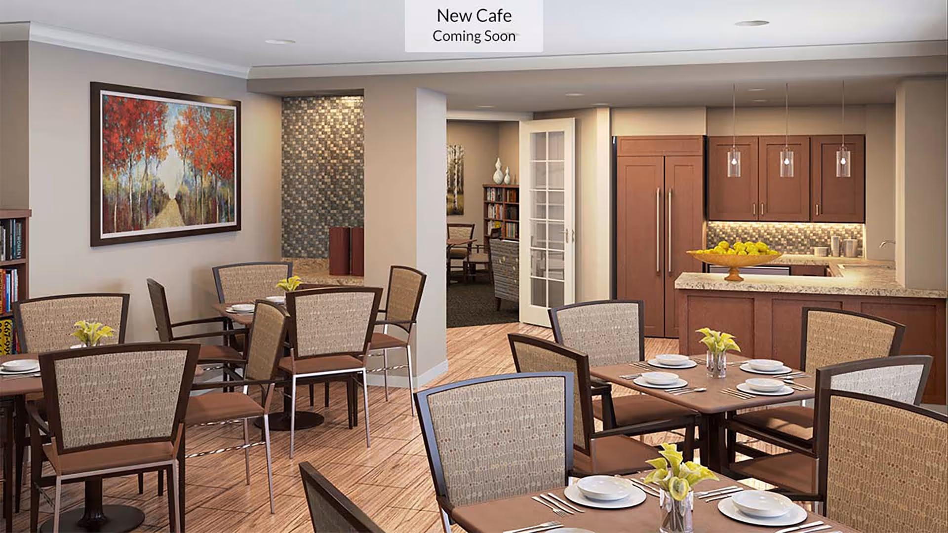 A dining area with several tables set with plates, bowls, utensils, and small flower vases. The room features wooden chairs with cushioned backs and seats, a kitchen area with wooden cabinets and a countertop holding a bowl of green apples, and a sign on the ceiling that reads 'New Cafe Coming Soon'. There is a colorful painting of trees with red leaves on the wall and a doorway leading to another room with bookshelves and chairs.