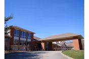 Front view of a brick senior living facility with a covered entry.