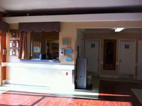 Interior reception area with a counter, curtains, and doors leading to hallways