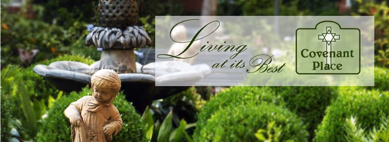 A garden scene featuring a stone statue of a child in front of a multi-tiered water fountain surrounded by green bushes and plants. Overlaid text reads 'Living at its Best' alongside the Covenant Place logo.