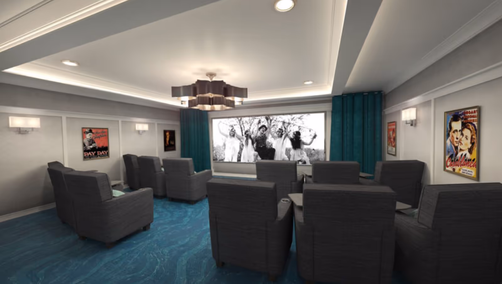 A small movie theater room with several rows of dark gray armchairs facing a large screen displaying a black and white film scene. The room has blue carpet, gray walls with framed vintage movie posters, teal curtains on either side of the screen, and a modern ceiling light fixture.