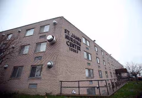 Exterior brick building labeled St. James Nursing Center with multiple windows.