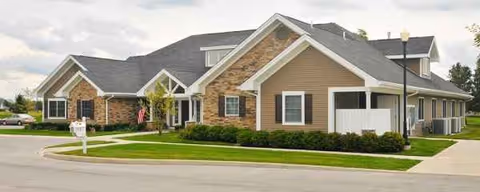 Exterior view of Otterbein Perrysburg SeniorLife Neighborhood building with manicured lawn and driveway.