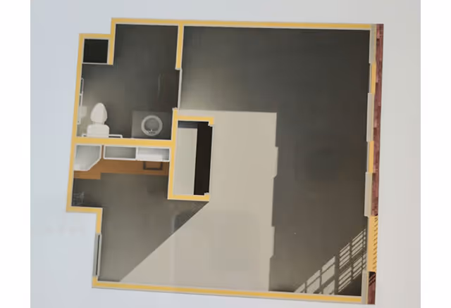 Architectural floor plan showing a layout with a bathroom area including a toilet and sink, and an open space likely for living or other uses.