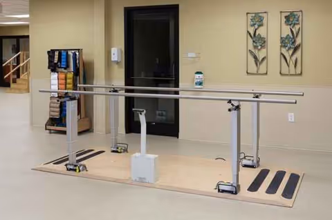 Interior rehab area at Meridian Center with parallel bars for gait training.